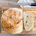 No-knead artisan sourdough bread on a wooden cutting board
