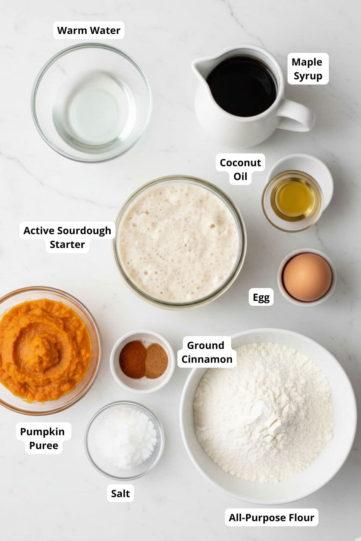 Ingredients for sourdough pumpkin cinnamon rolls arranged on a surface.