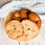 Sundried tomato bagels on a wooden round board.