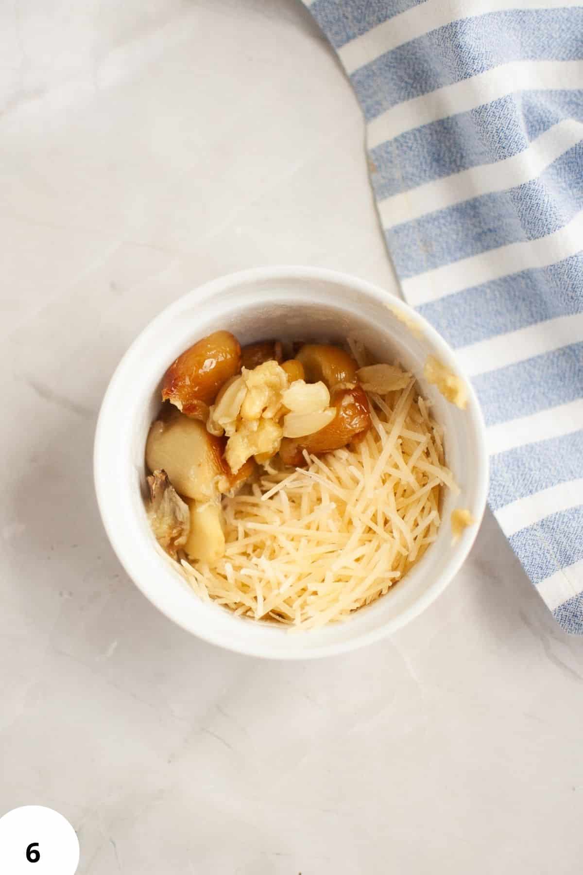 Close-up of garlic, cheese, and roasted garlic topping for sourdough bread.