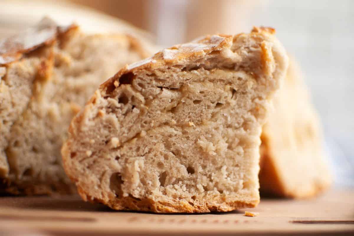 Fresh sourdough bread with roasted garlic and Parmesan cheese, perfect for artisanal baking.