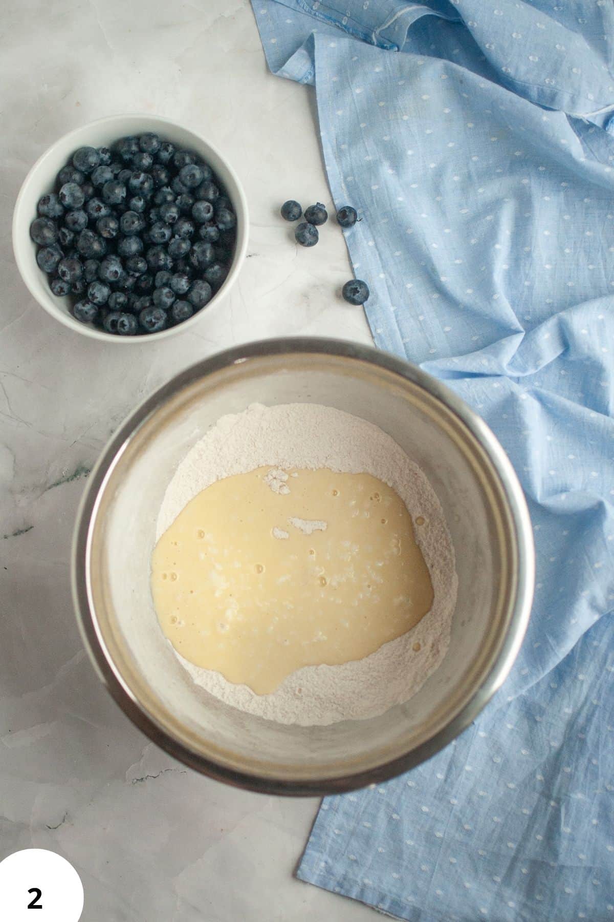 Sourdough discard batter with blueberries and lemon zest for quick bread.