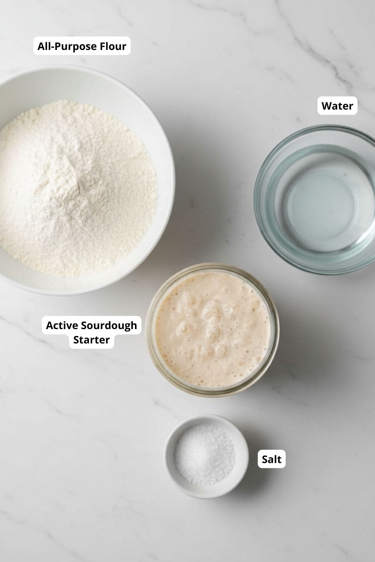 Ingredients for making sourdough rolls arranged on a countertop.