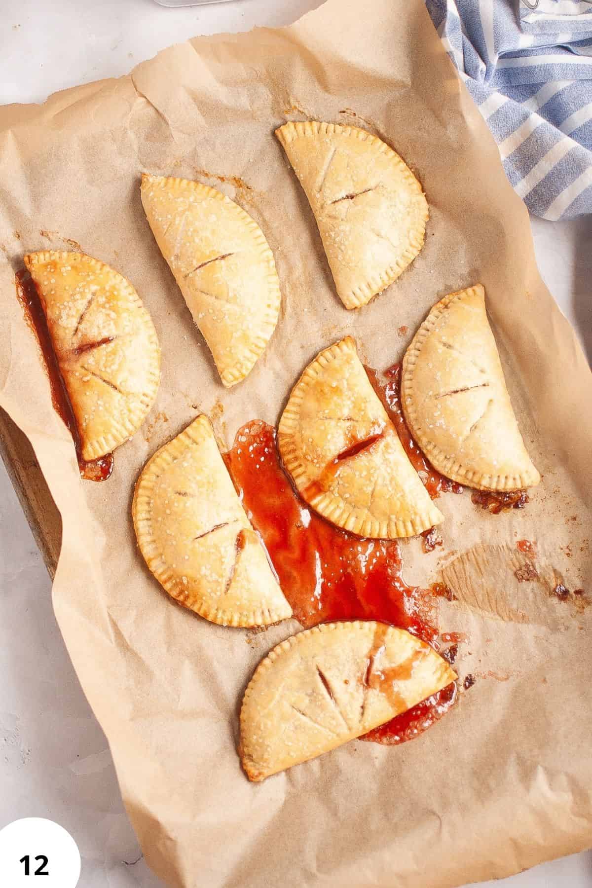 Homemade jam-filled sourdough hand pies on parchment paper.