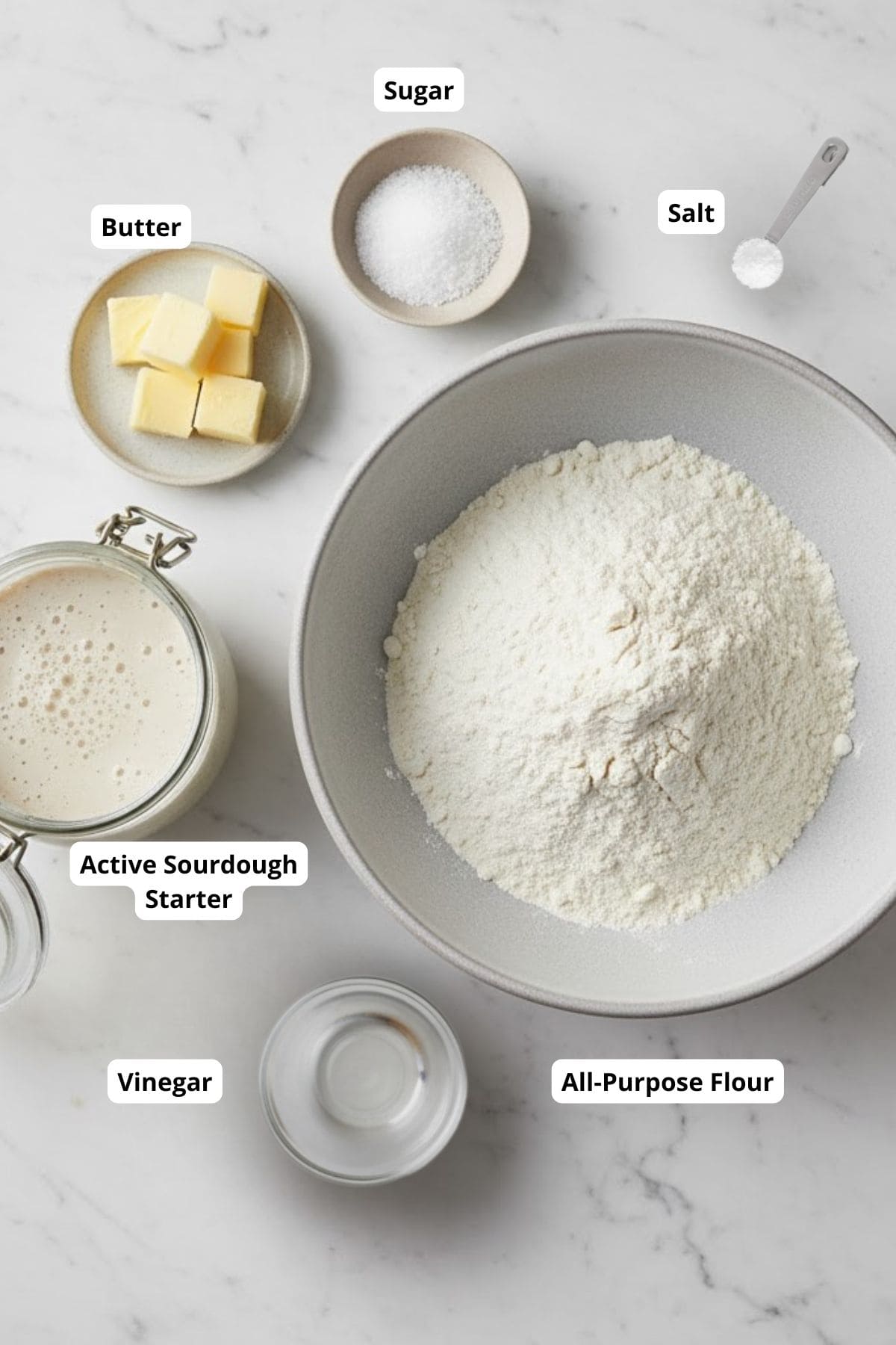 Ingredients for super simple jam-filled sourdough hand pies neatly arranged on a marble countertop.
