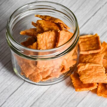 Sourdough discard crackers in a small glass jar.