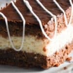 Sourdough coconut and chocolate cake square on a white plate.