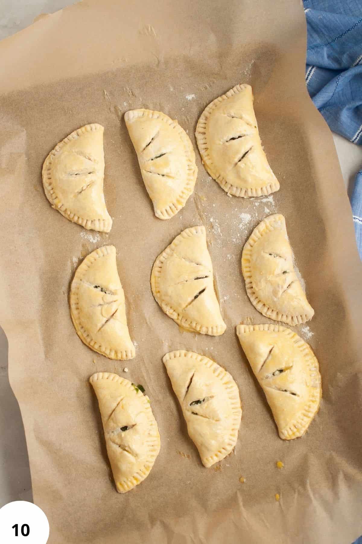 Freshly baked sourdough hand pies filled with spinach and feta cheese.