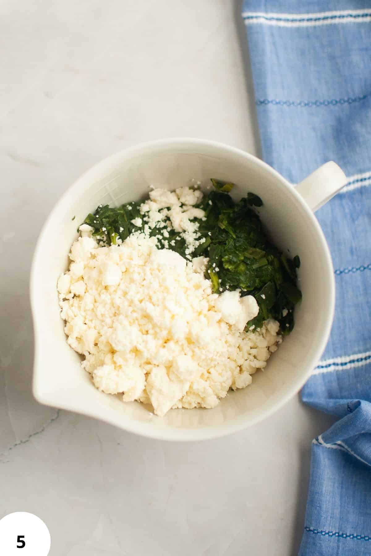 Freshly prepared sourdough dough filled with spinach and feta cheese for delicious hand pies.