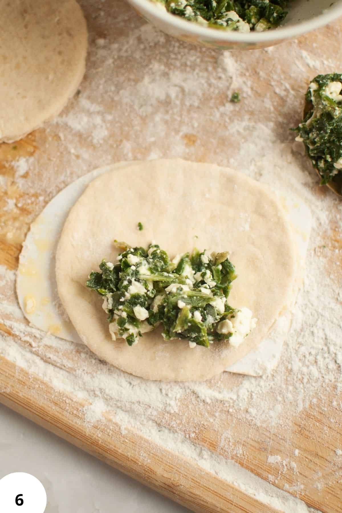 Preparing spinach and feta filling for savory sourdough hand pies.