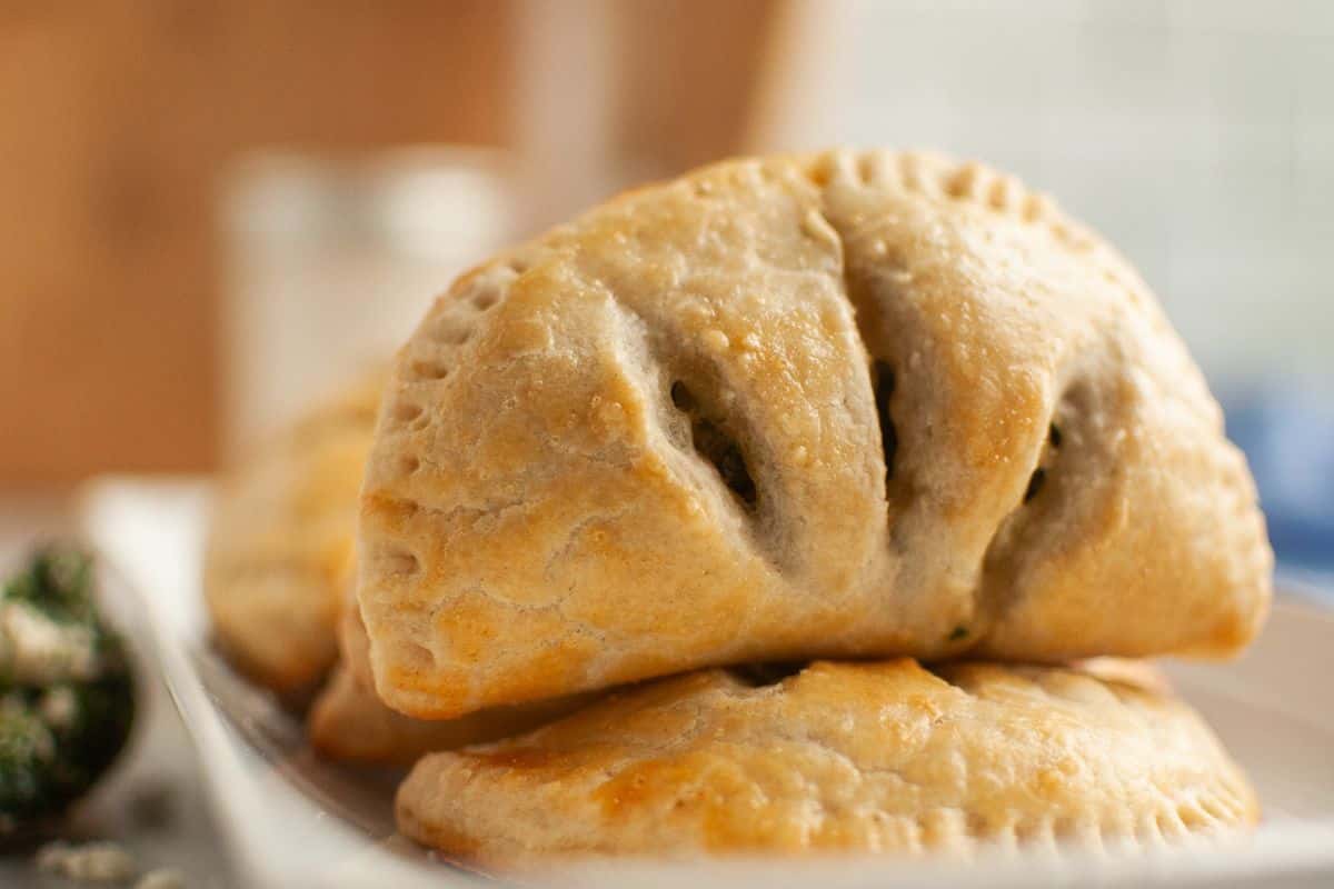 Close-up of savory sourdough hand pies filled with spinach and feta cheese.