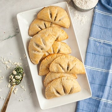Delicious sourdough hand pies filled with spinach and feta cheese, perfect for a savory snack or mea.
