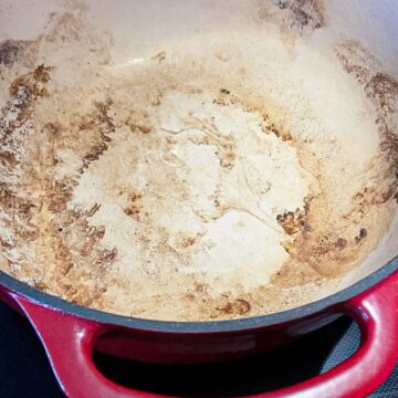 The bottom of enameled cast iron Dutch oven, full of stains.