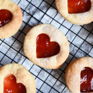 Sourdough Linzer cookies cooling down on a cooling rack.