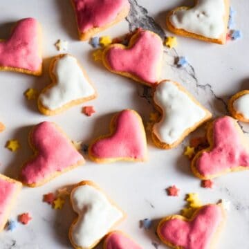 Sourdough Valentines Day sugar cookies on a marble counter.
