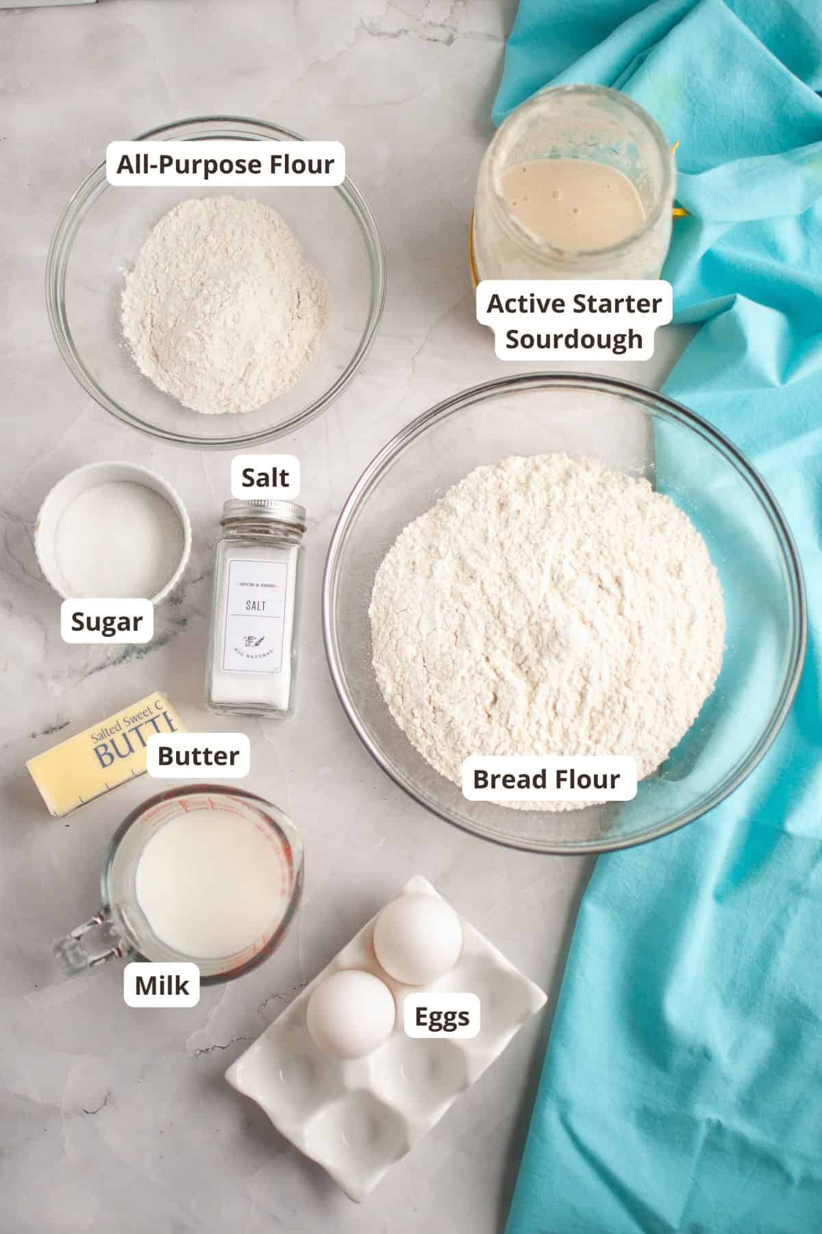 Ingredients for sourdough bread including flour, eggs, milk, and starter.