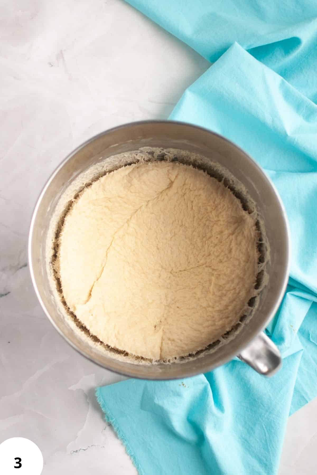 Dough in a metal bowl ready for stretching and folding to develop gluten.