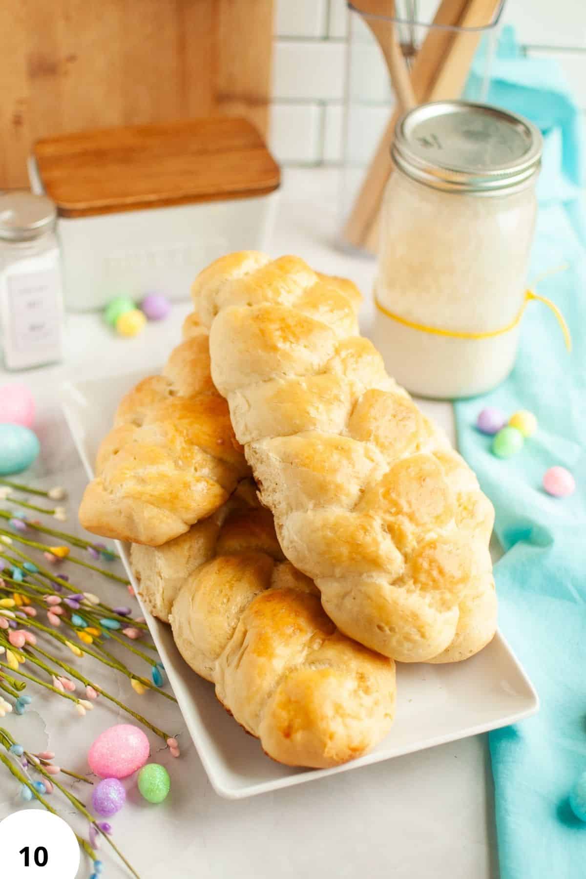 Delicious homemade bread rolls with a golden crust on a white plate.