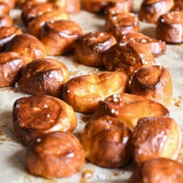 Sourdough discard pretzel bites on a parchment sheet.