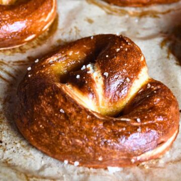 Sourdough discard pretzel on a parchment paper lined baking tray.
