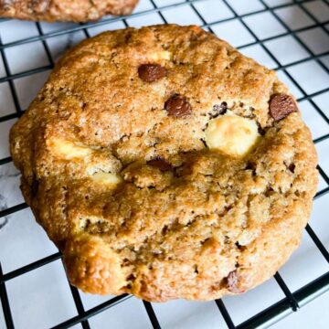 Photo of a double chocolate cookie on a wire rack.