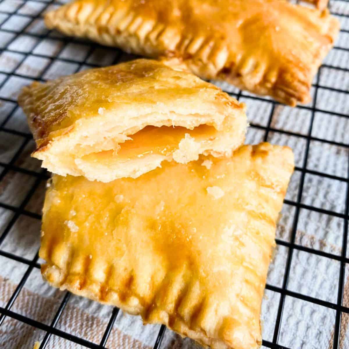A homemade sourdough discard pop tart split in half on a wire rack.