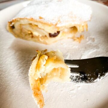 A fork full of apple strudel.