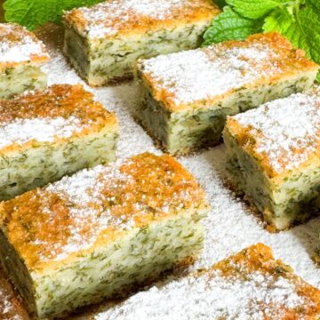 Lemon balm sheet cake on a wooden cutting board.