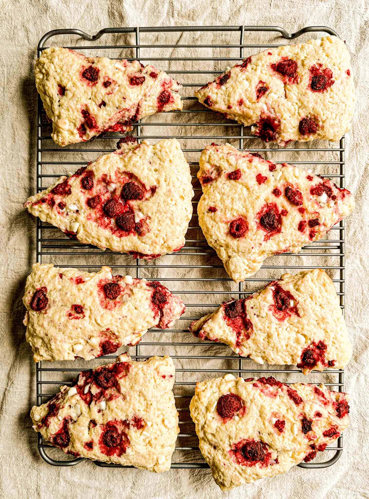 Just baked sourdough scones on a black wire rack.