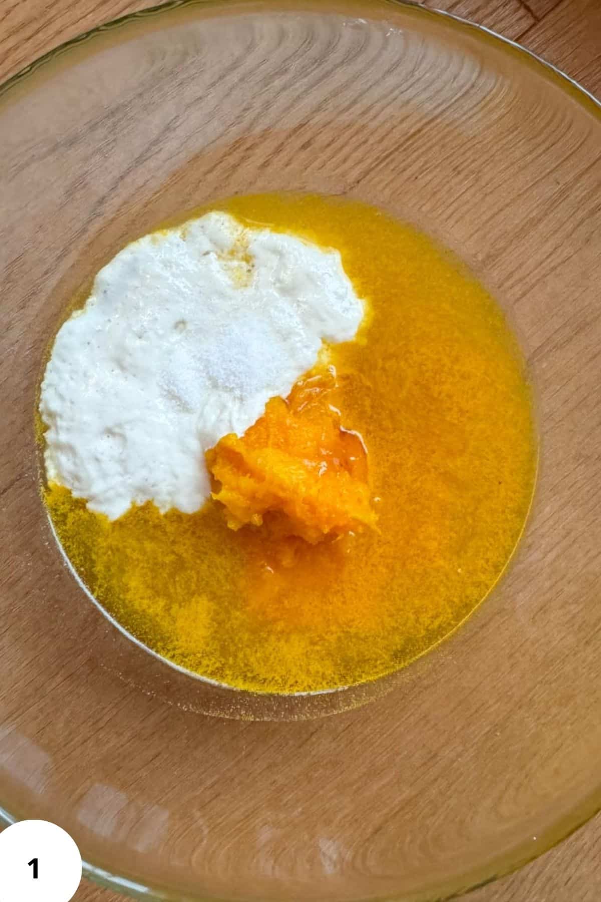 Ingredients for sourdough pumpkin bread in a glass bowl.