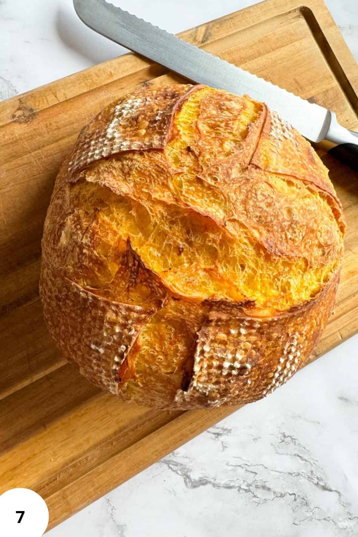 Sourdough pumpkin bread on a wooden cutting board.