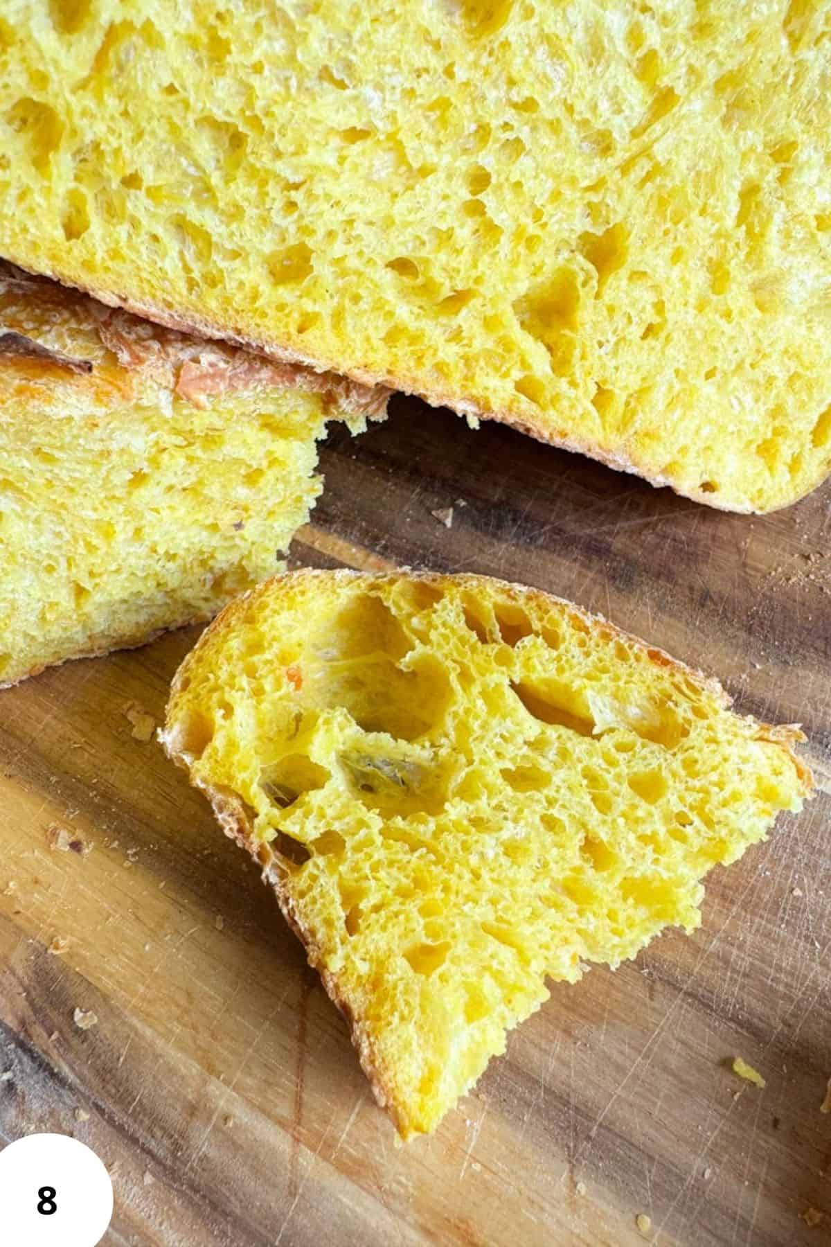 Sourdough pumpkin bread on a wooden cutting board.