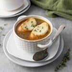 Served French onion soup with spoon on the side.