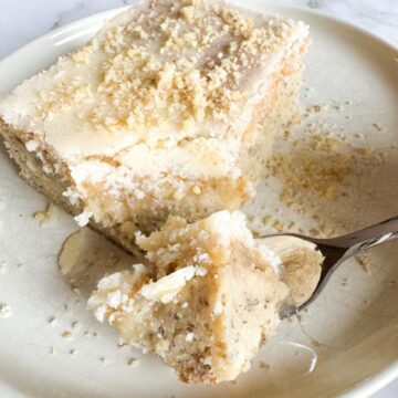 Sourdough banana bar piece on a plate with a fork of the bar.