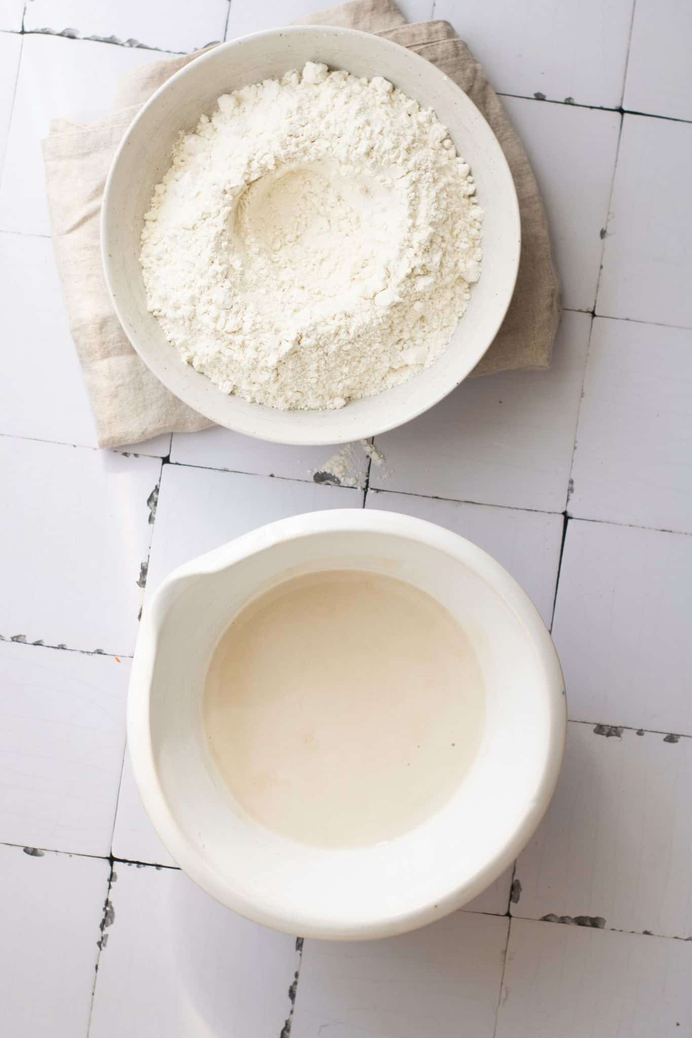 Two bowls of dry and liquid ingredients.