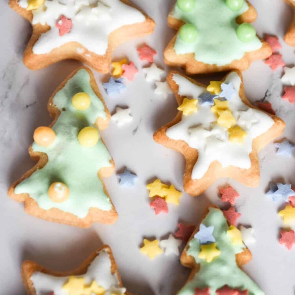Frosted sugar cookies on a marble background.