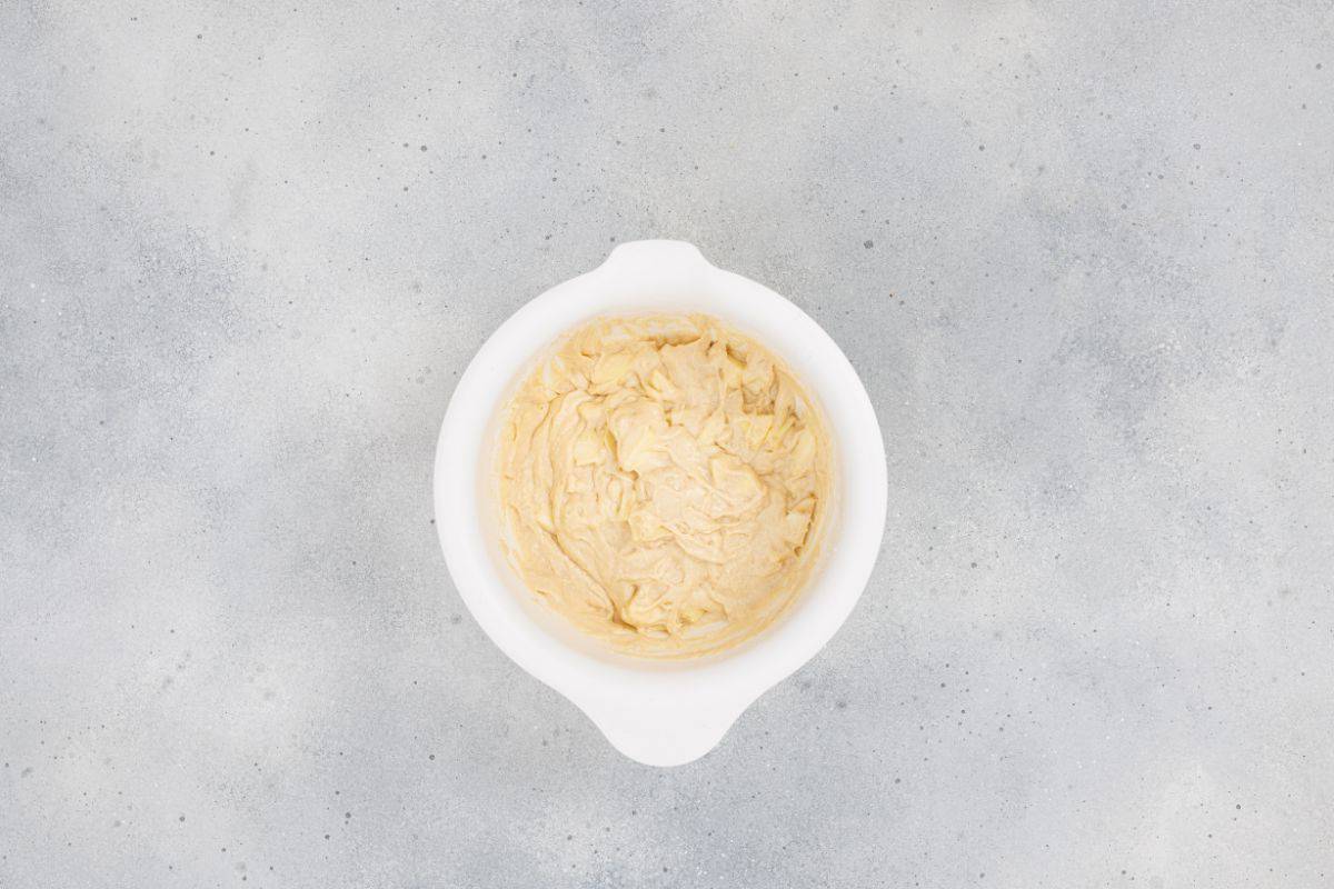 Ingredients being mixed together in a medium bowl.