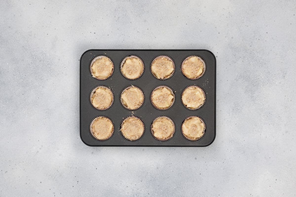 Freshly baked apple cinnamon muffins still in the baking tin.