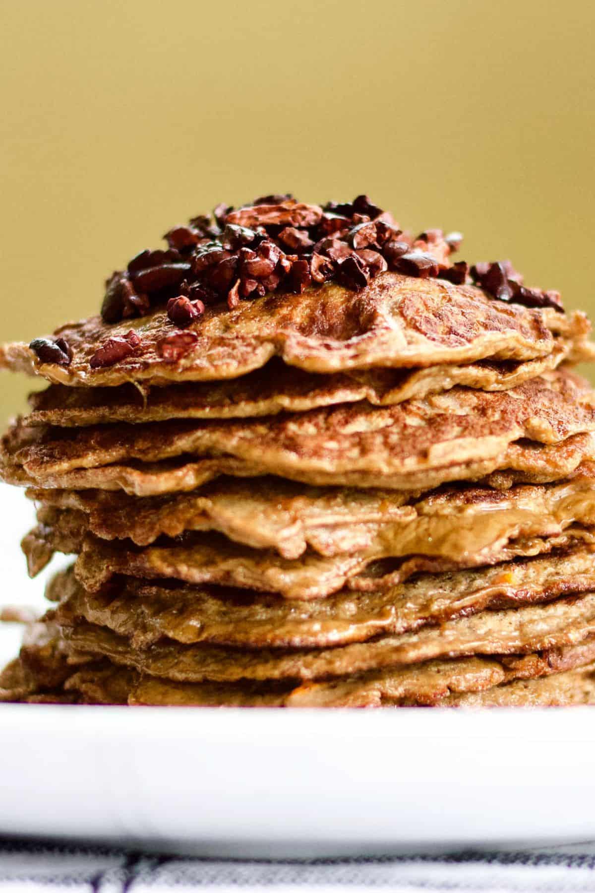 A stack of layered apple carrot pancakes on a plate.