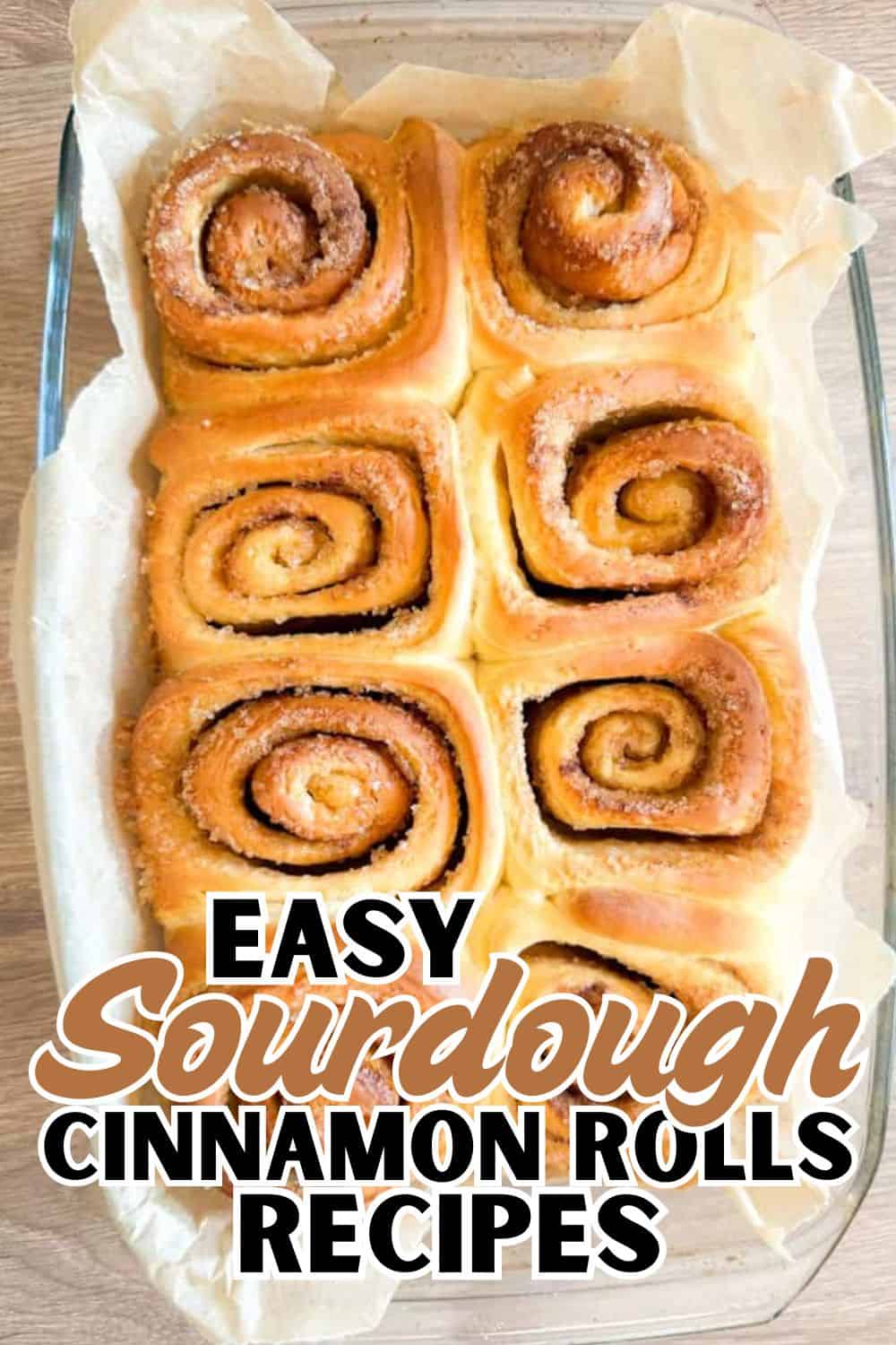 Freshly baked cinnamon rolls with swirled filling in a glass baking dish.
