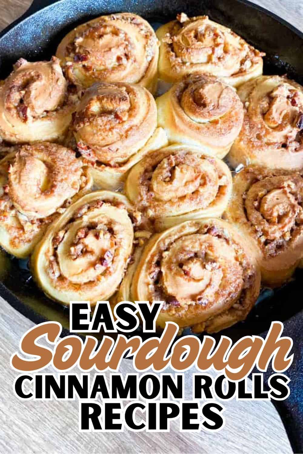 Freshly baked sourdough cinnamon rolls in a skillet, golden and gooey.