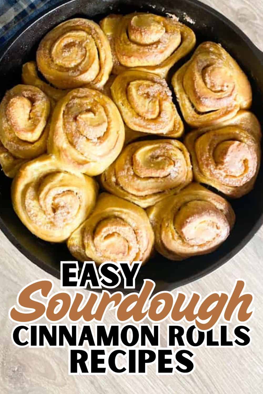 Freshly baked cinnamon rolls in a round baking pan, showcasing soft, swirled dough with cinnamon fil.