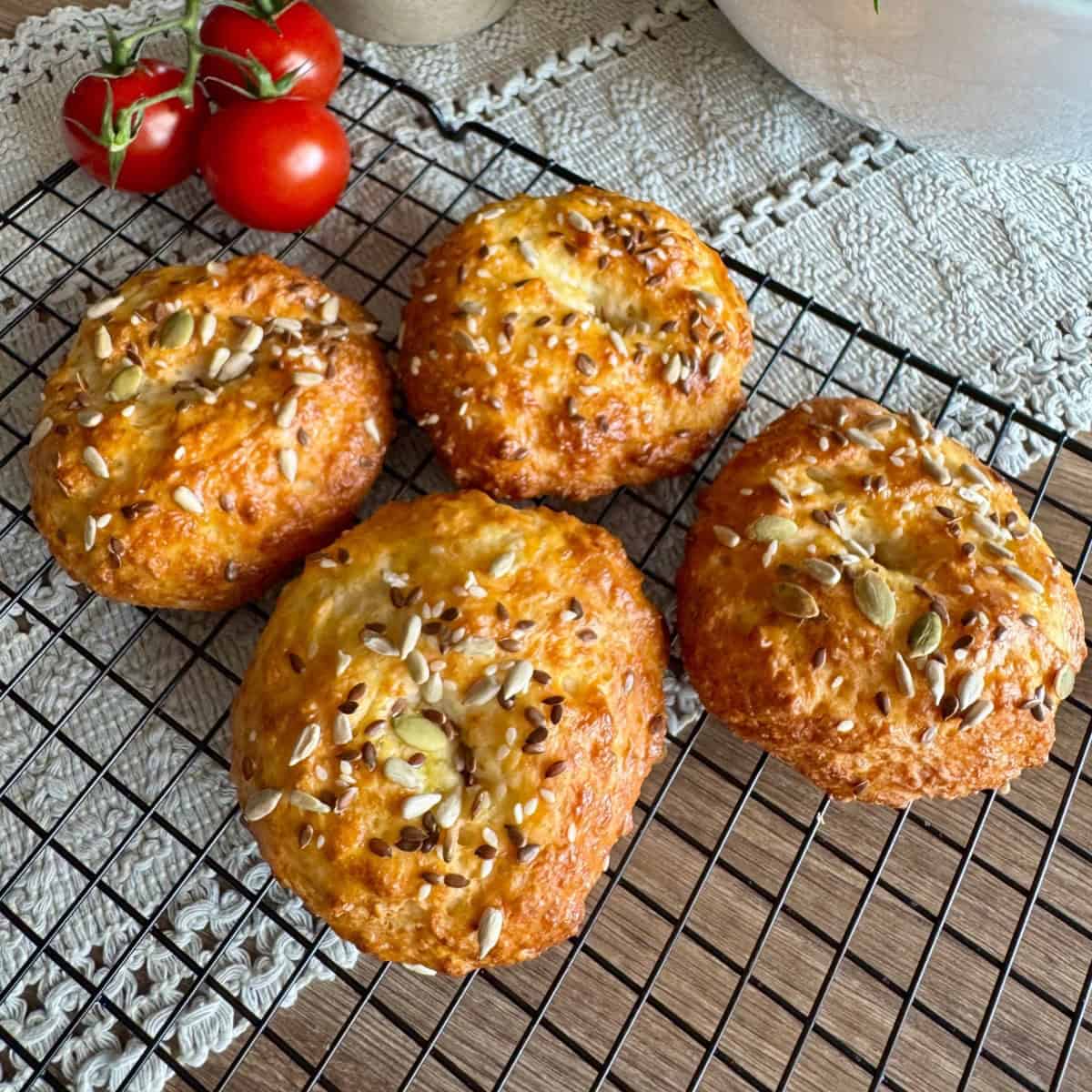Freshly baked bagels resting on a cooling rack.