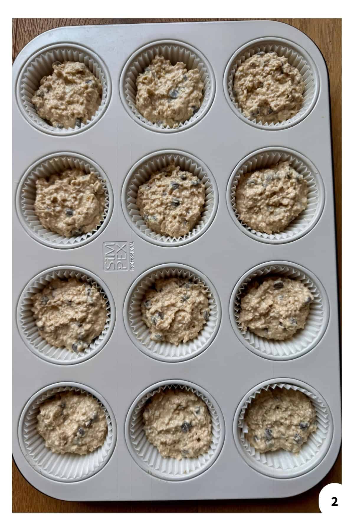 A muffin tin filled with the batter mixture ready to bake.