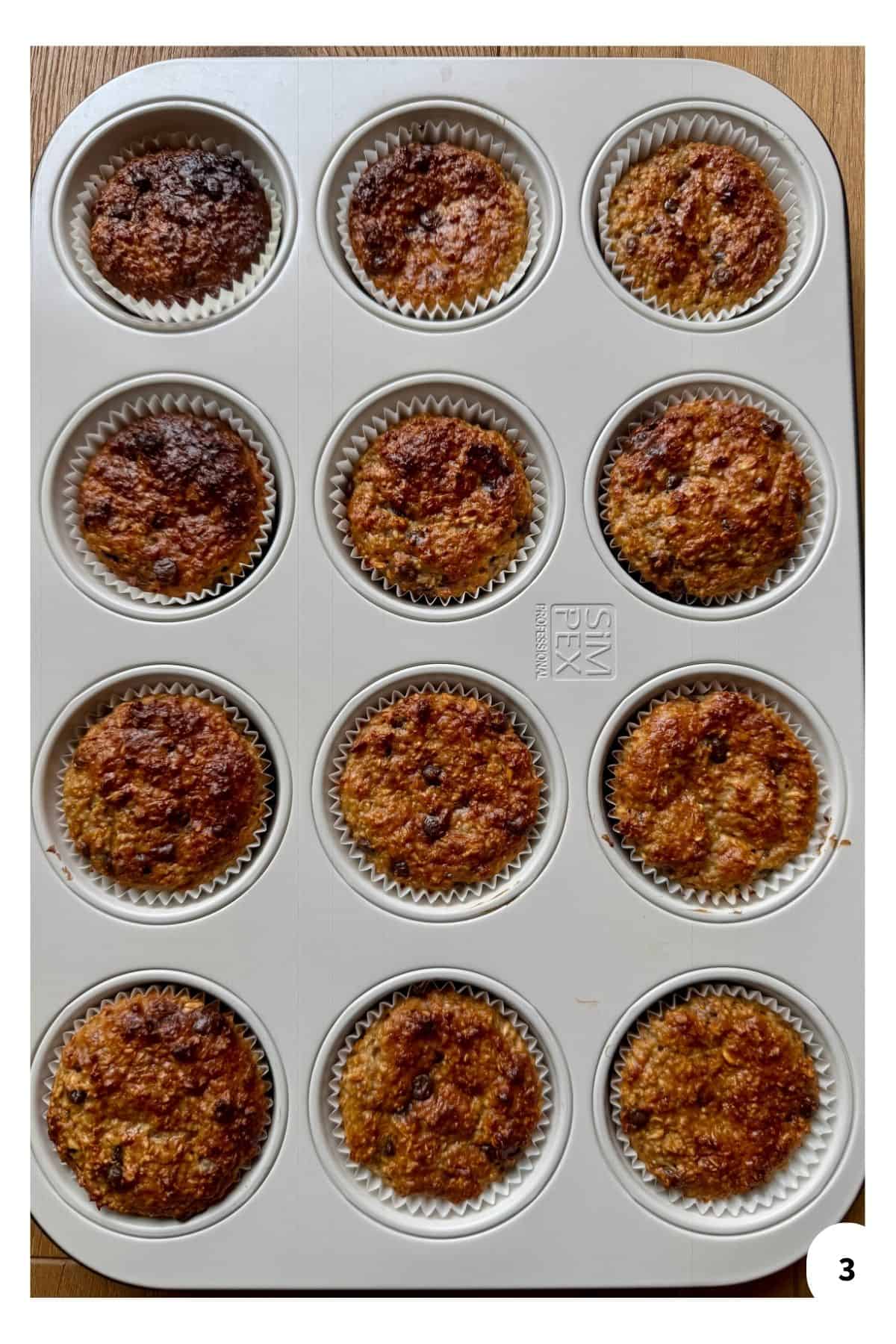 A muffin tin filled with golden, freshly baked oatmeal muffins.