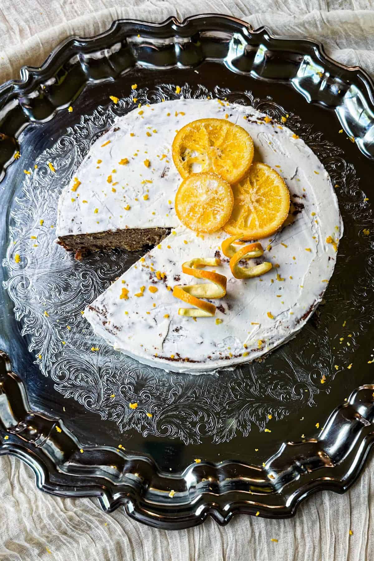 Christmas cake with dried fruits, being sliced to reveal its moist, fruit-studded interior.
