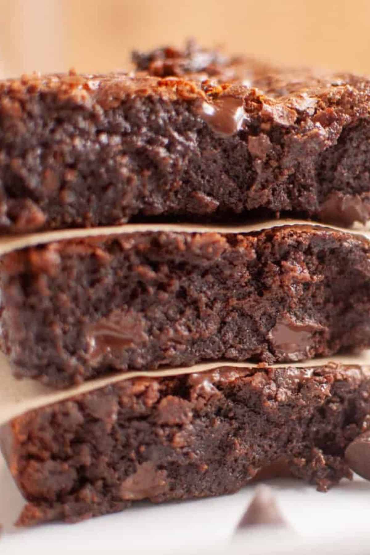 Close-up of fudgy sourdough discard brownies stacked in layers, showing their rich, moist texture.
