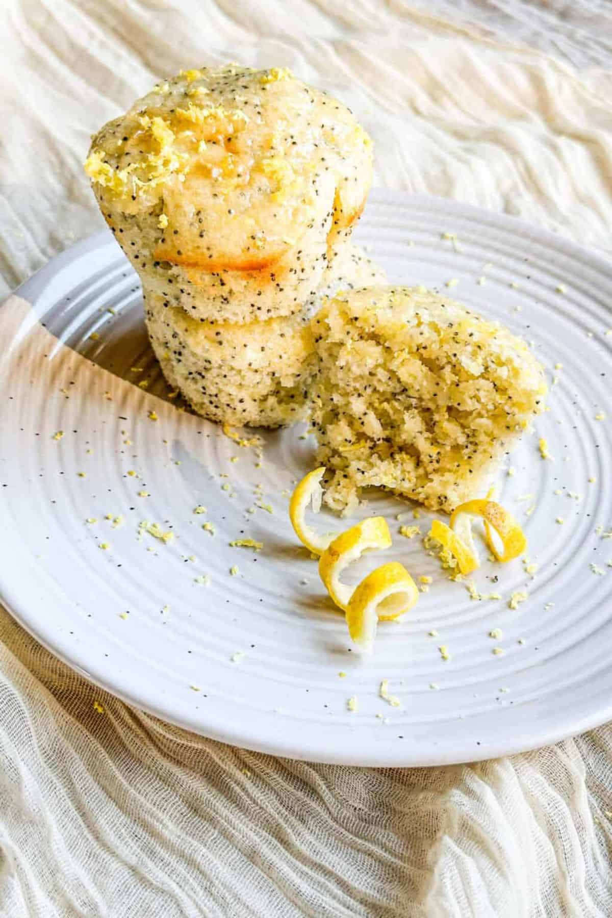 Muffins made with sourdough discard and poppy seeds, served on a plate.