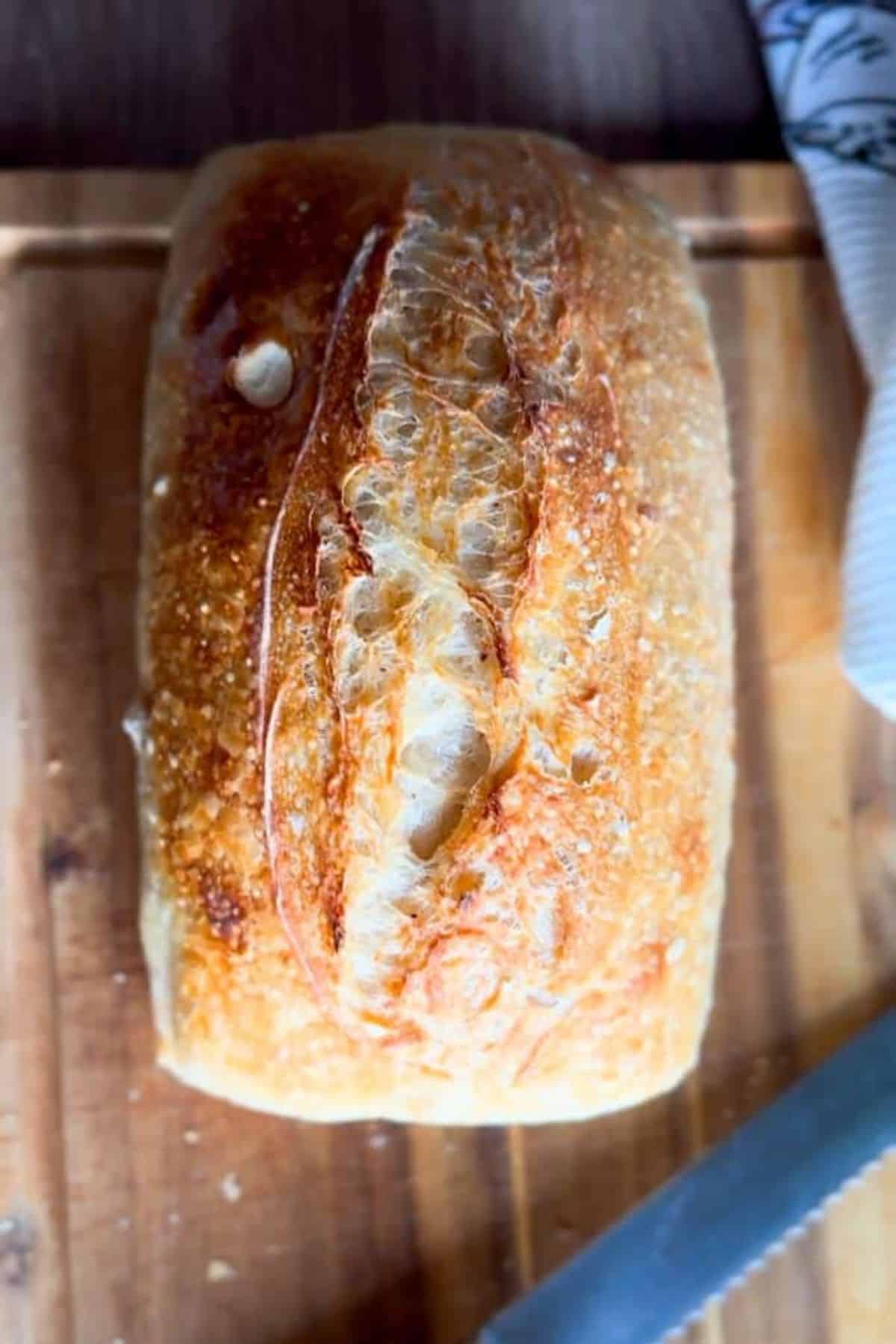 Loaf of bread served on a wooden board.