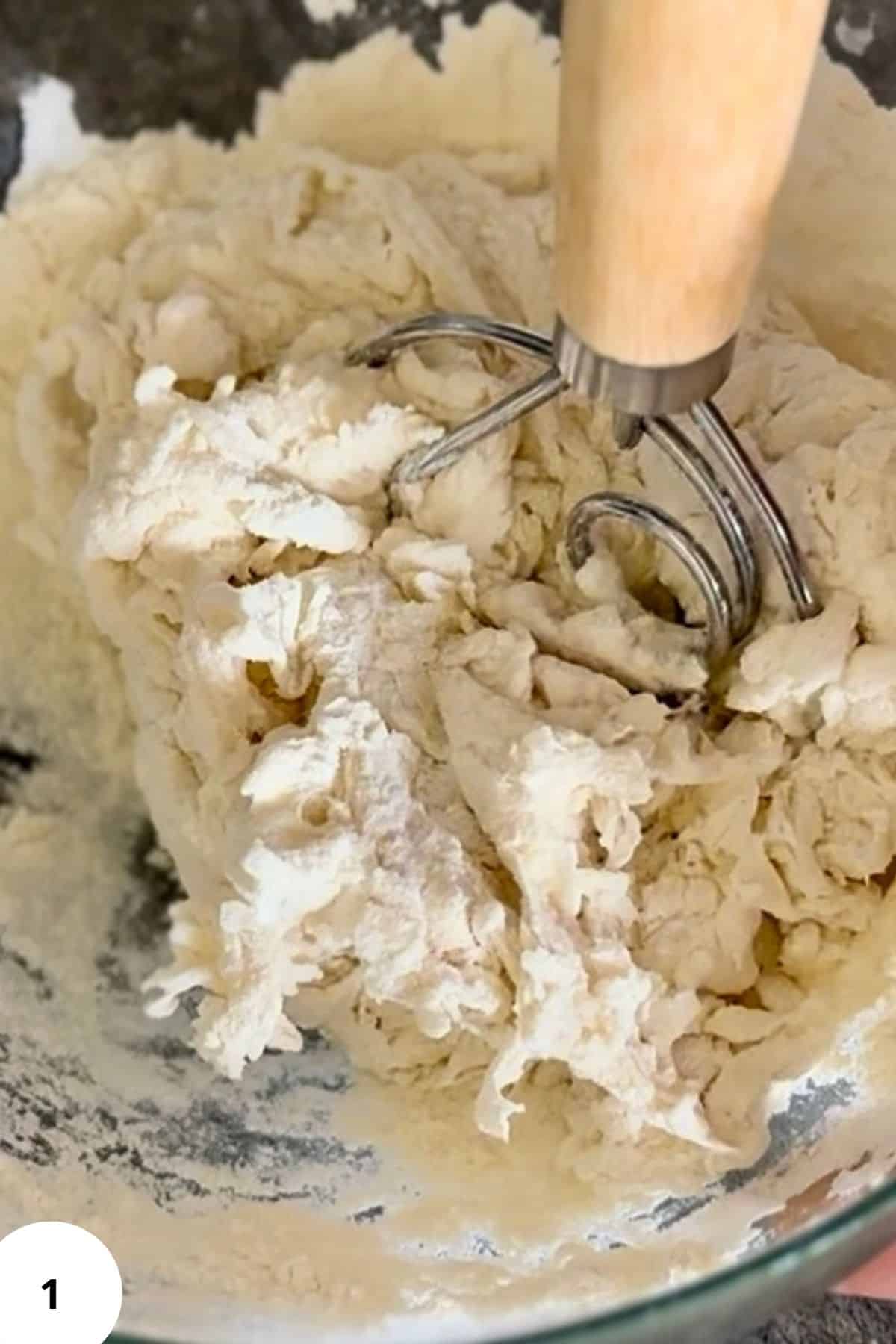 Dough mixture in a mixing bowl, ready for resting or kneading.